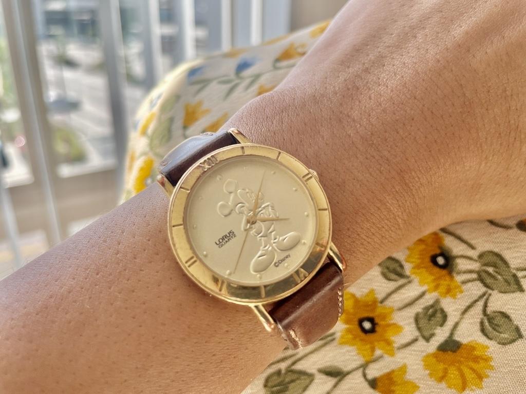 Mickey Mouse watch on Luna’s wrist holding fabric 