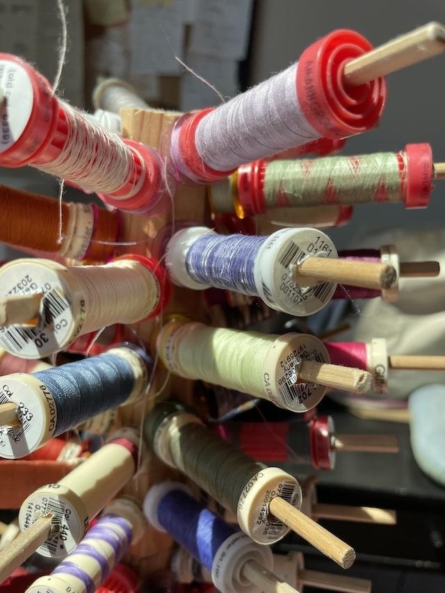 Close up of different colors of thread on spools in Luna's Sewing Room