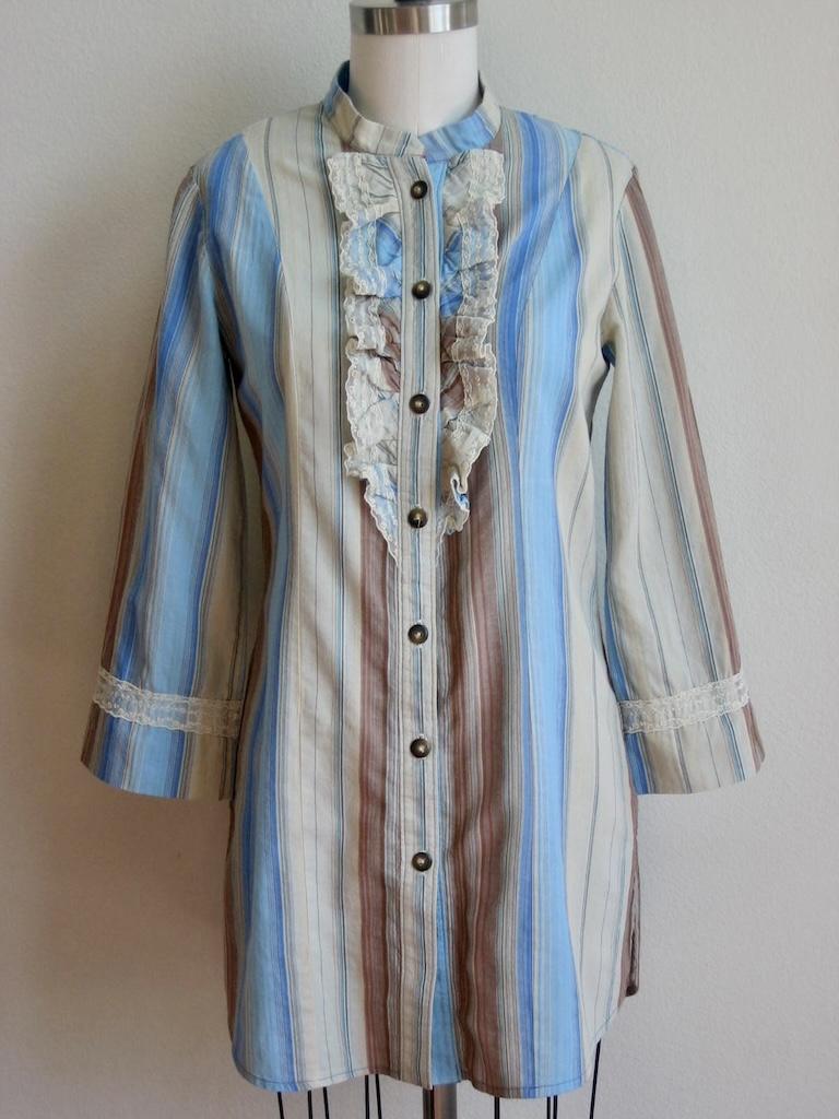 Button-up tunic made with Simplicity S2447 pattern in striped fabric with ruffles and long sleeves on a dress form