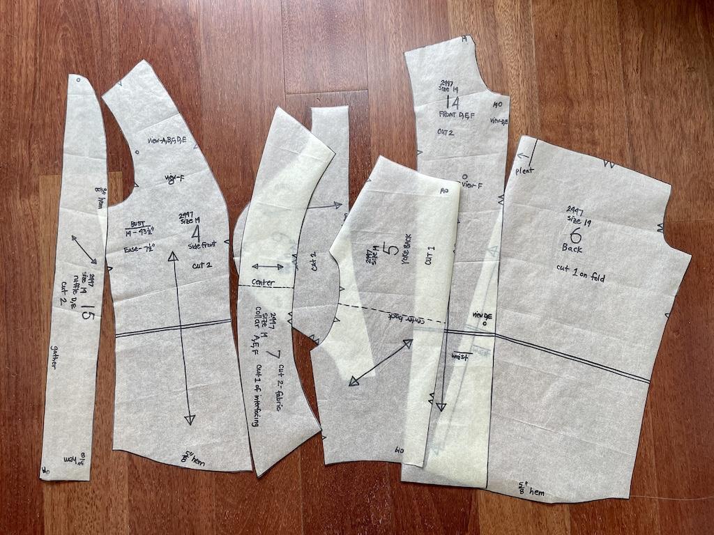 View of sewing pattern pieces that Luna graded in size on the floor