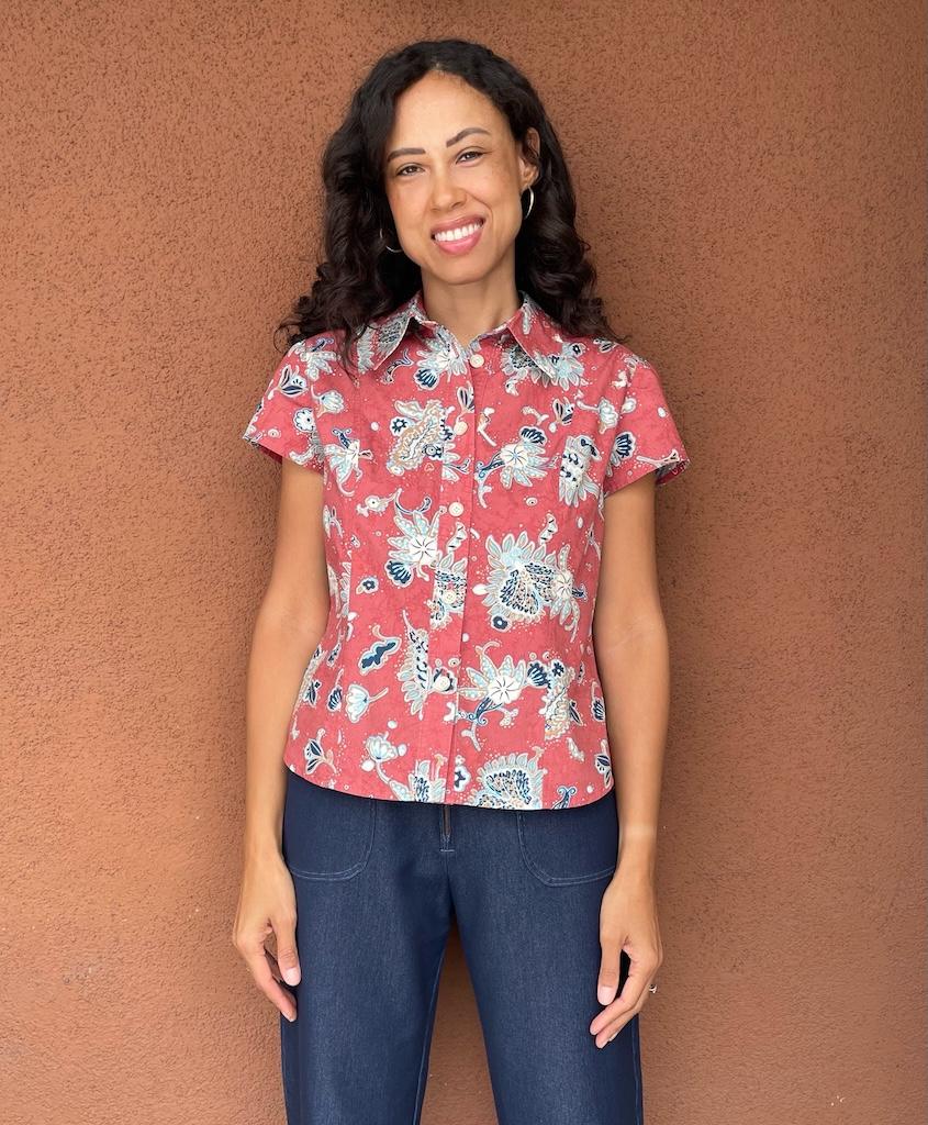 Front view of Luna smiling, wearing her button-up shirt in bold fabric print, made with Simplicity S2447 pattern