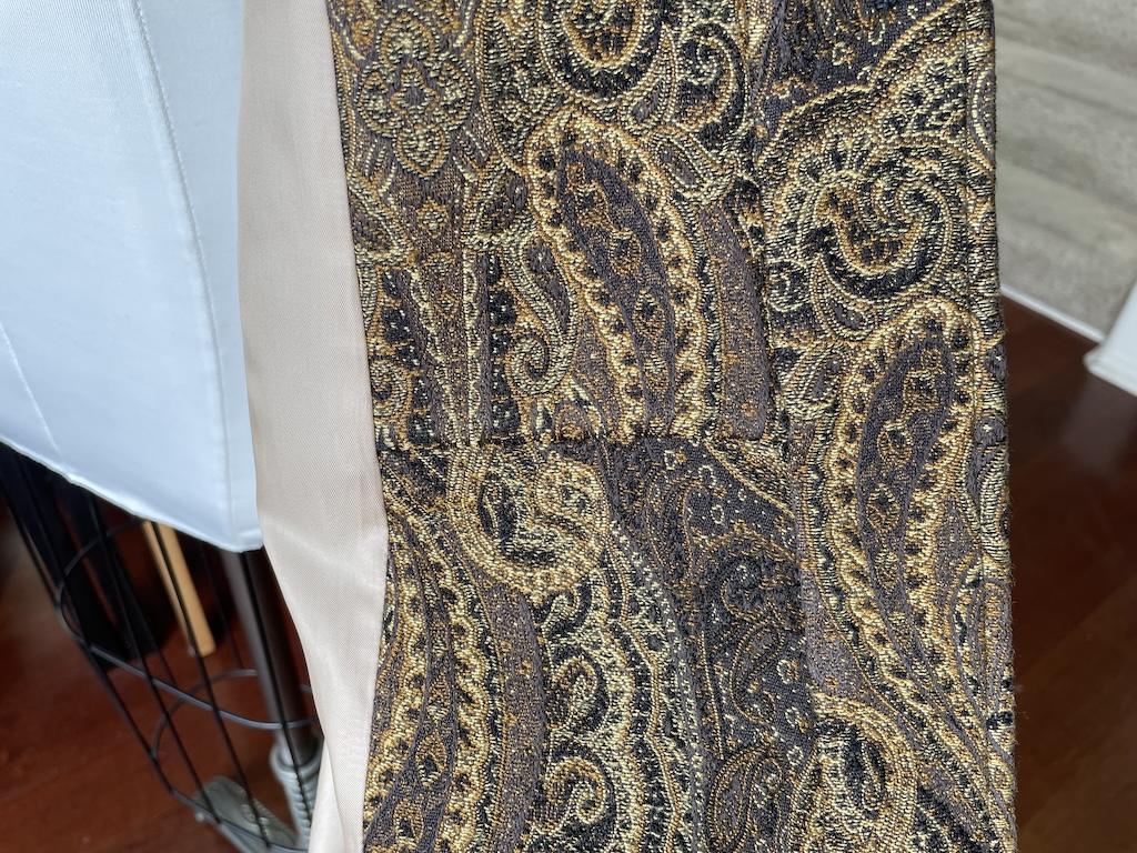 Close up inside view of Luna’s dress coat on the dress form, showing panel sewn together