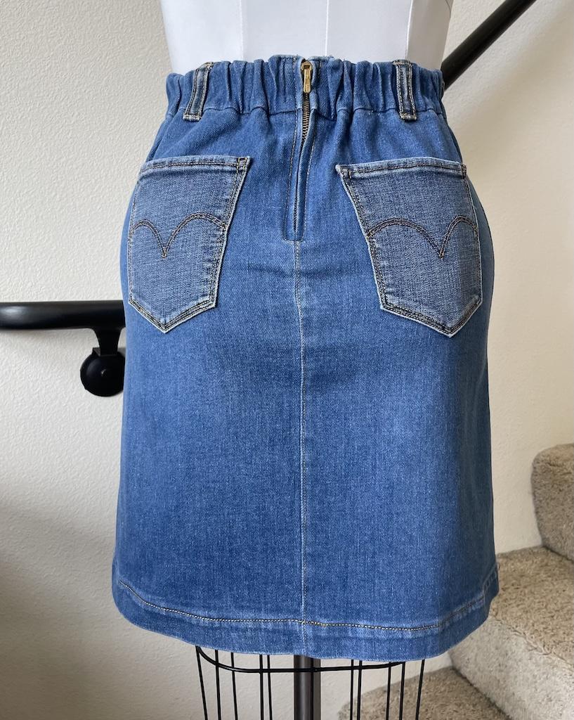 Back of Luna’s denim skirt showing the back elastic waistband hack with zipper and back pockets on the dress form