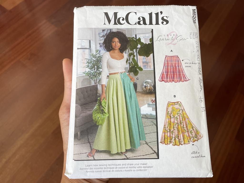 Luna holding McCall’s M8205 circle skirt sewing pattern envelope 