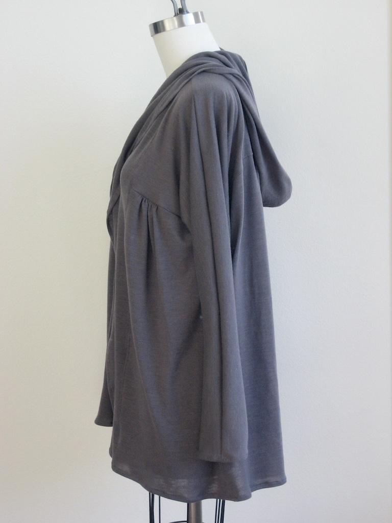 Side view of Luna’s cardigan with hood made from gray sweater knit fabric on the dress form
