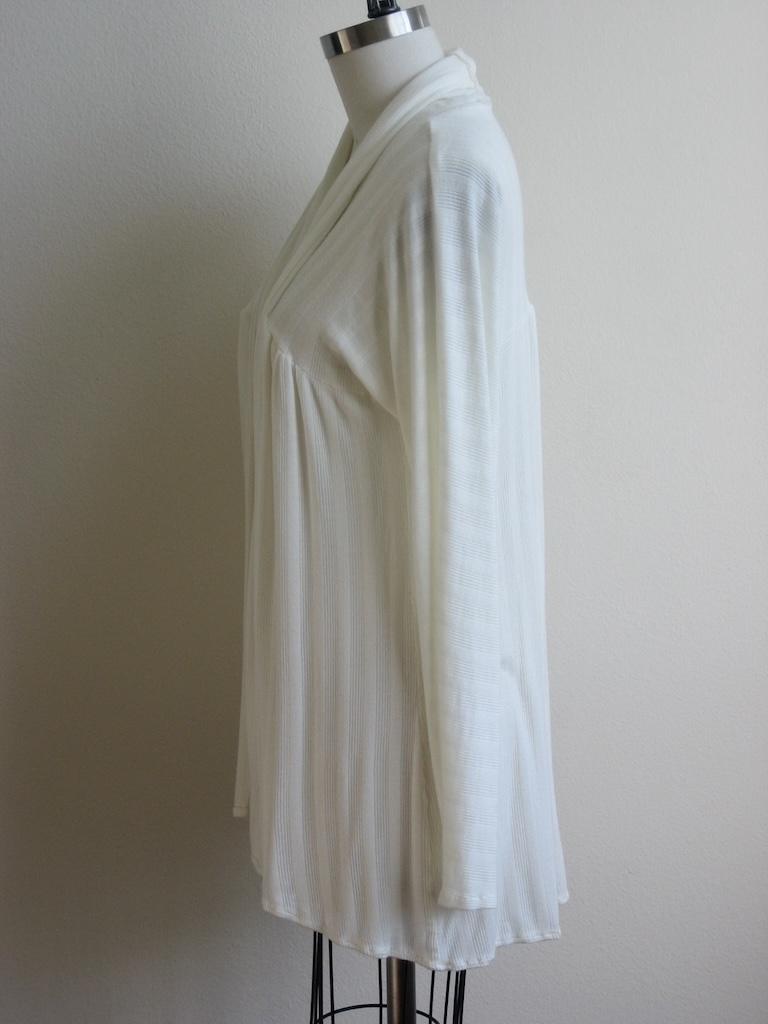 Side view of Luna’s DIY cardigan made from white knit fabric on the dress form, sewn from McCall’s M5713 pattern.