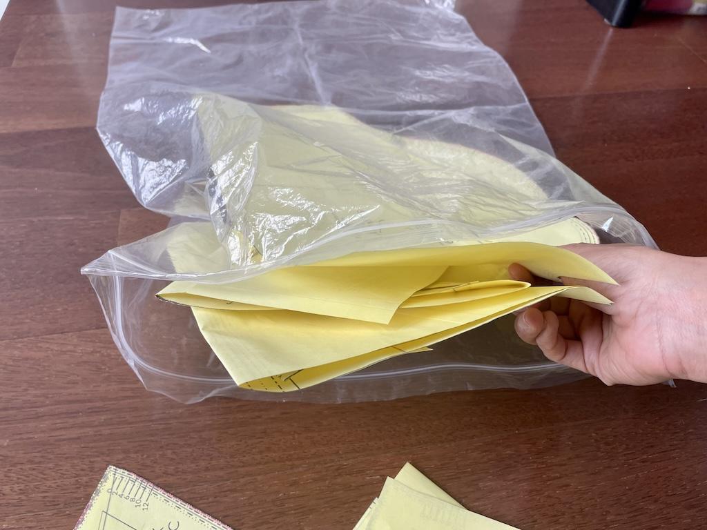 Close up of Luna’s hand storing PDF patterns in a large plastic bag