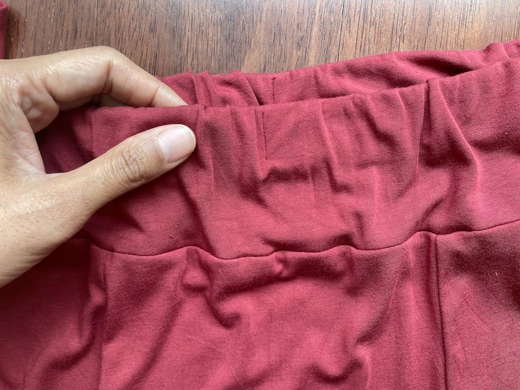 Close up of the yoke of Luna’s handmade knit skirt showing the elastic for the waist.