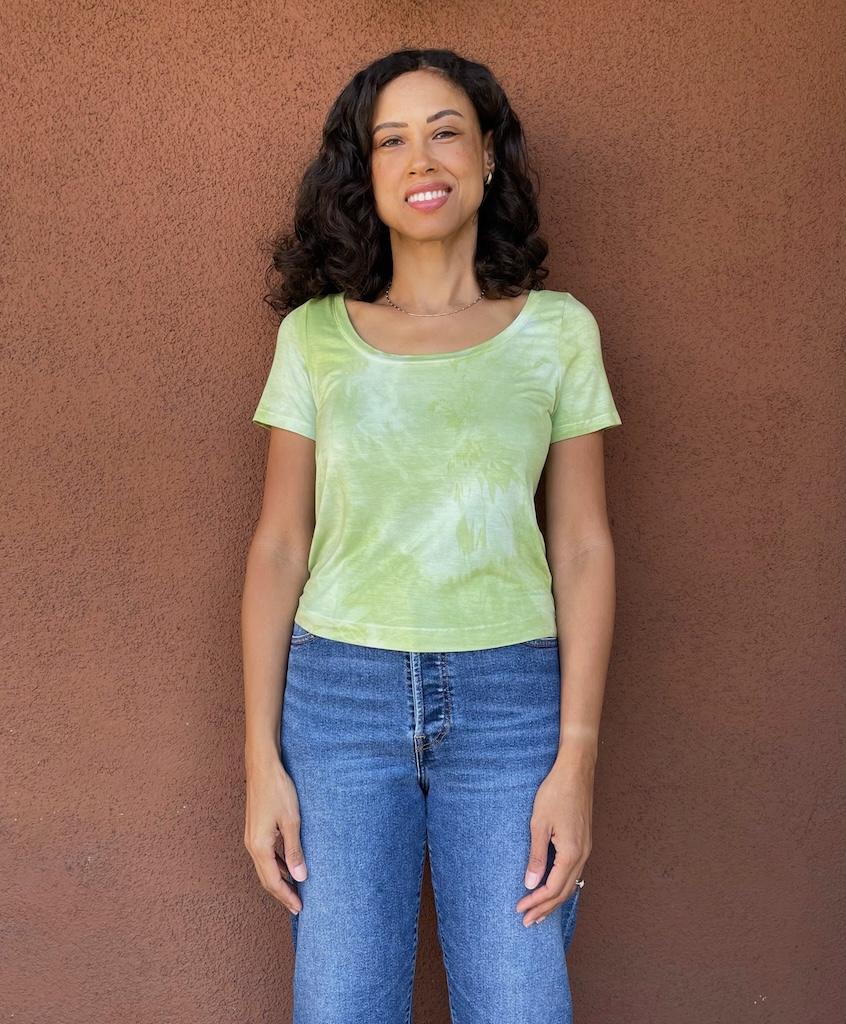 Luna smiling with her hands down her sides, wearing her T-shirt in rayon knit 