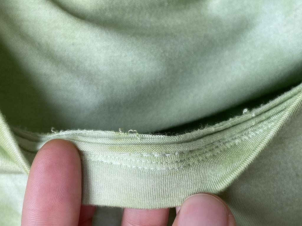 Close up of the inside neckband of Luna’s T-shirt