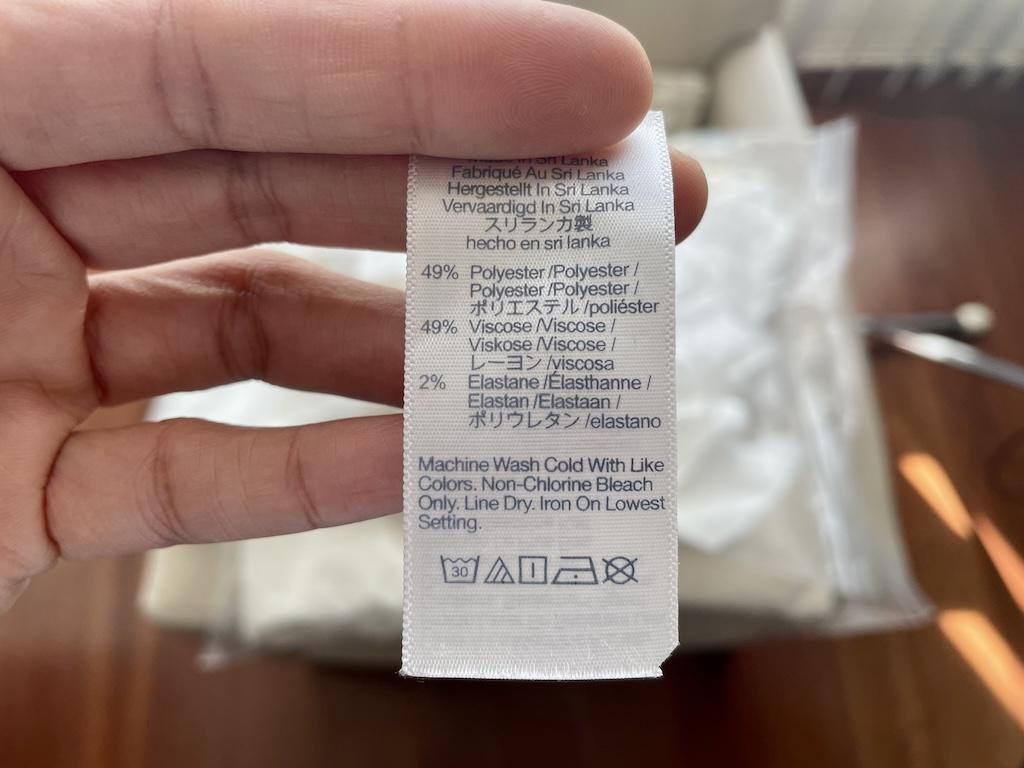 Close up of clothing tag that shoes what materials clothes are made up