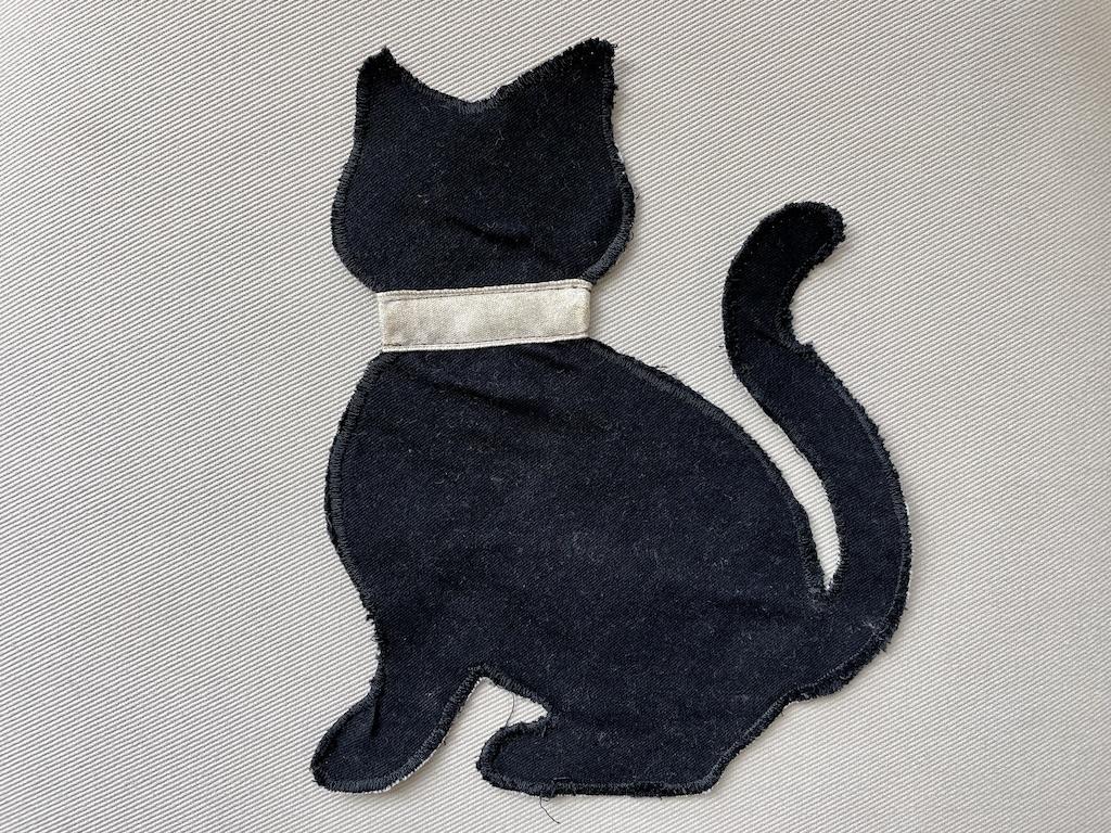 Handmade applique of black cat with collar made from a ribbon made by Luna