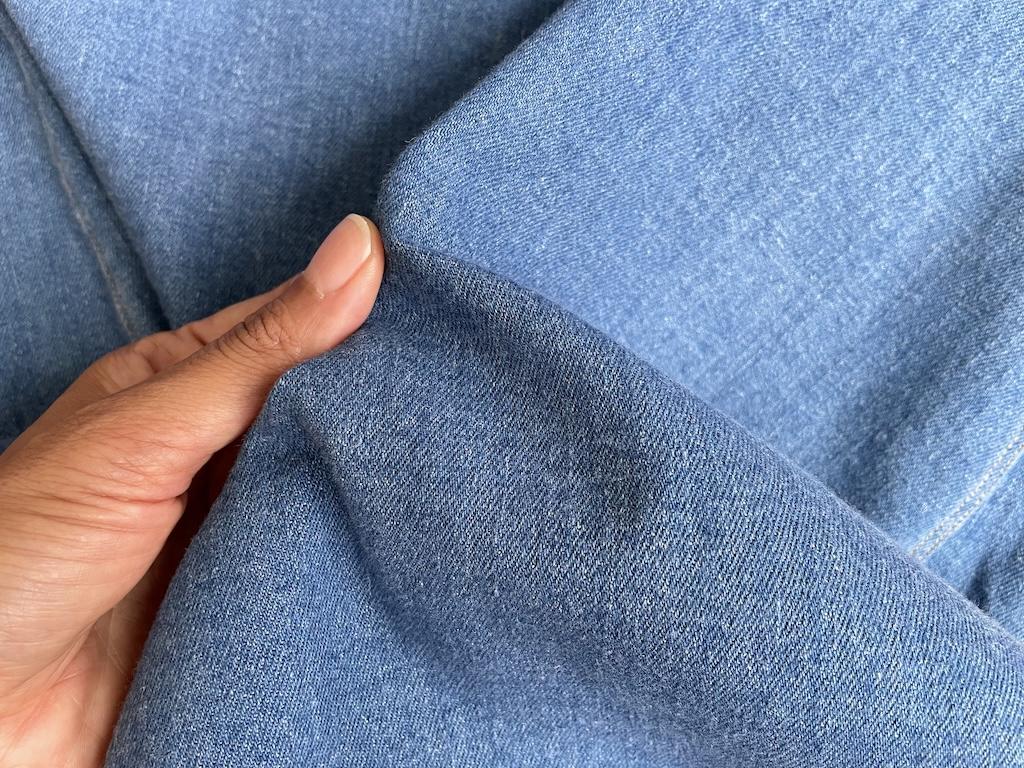 Close up of Luna’s denim skirt showing the fabric after fading it out by washing it