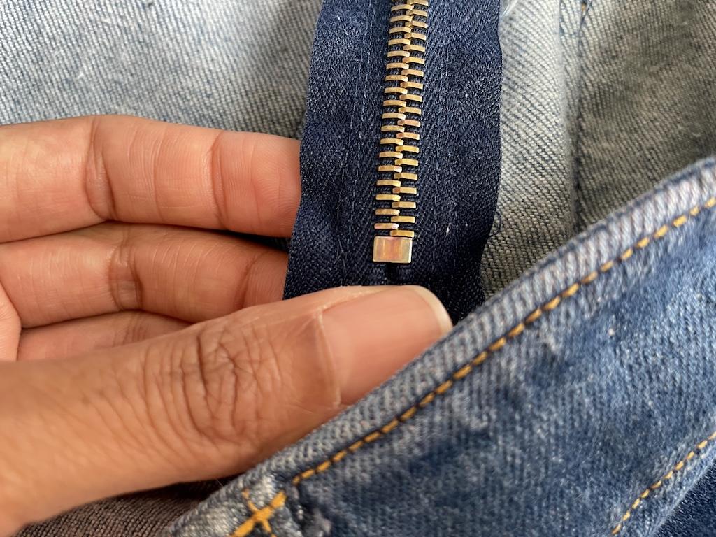 Close up of the inside of Luna’s denim skirt showing the metal zipper and how it was stitched to the garment