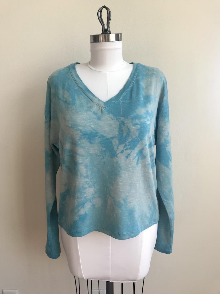 Front view of Luna’s tie-dyed top with long sleeves made from Simplicity S8950 pattern hanging on the dress form