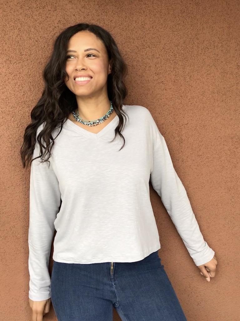 Luna smiling wearing her DIY V-neck top in light blue knit fabric
