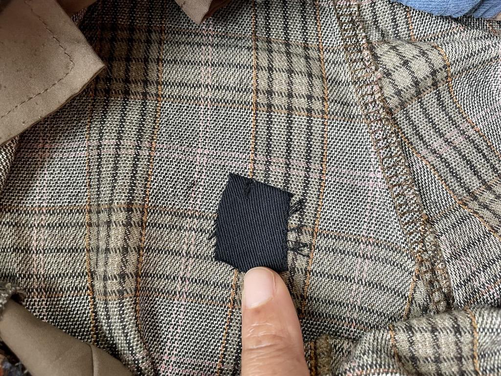 Close up of Luna’s finger touching the small patch she created on the hole in her pants