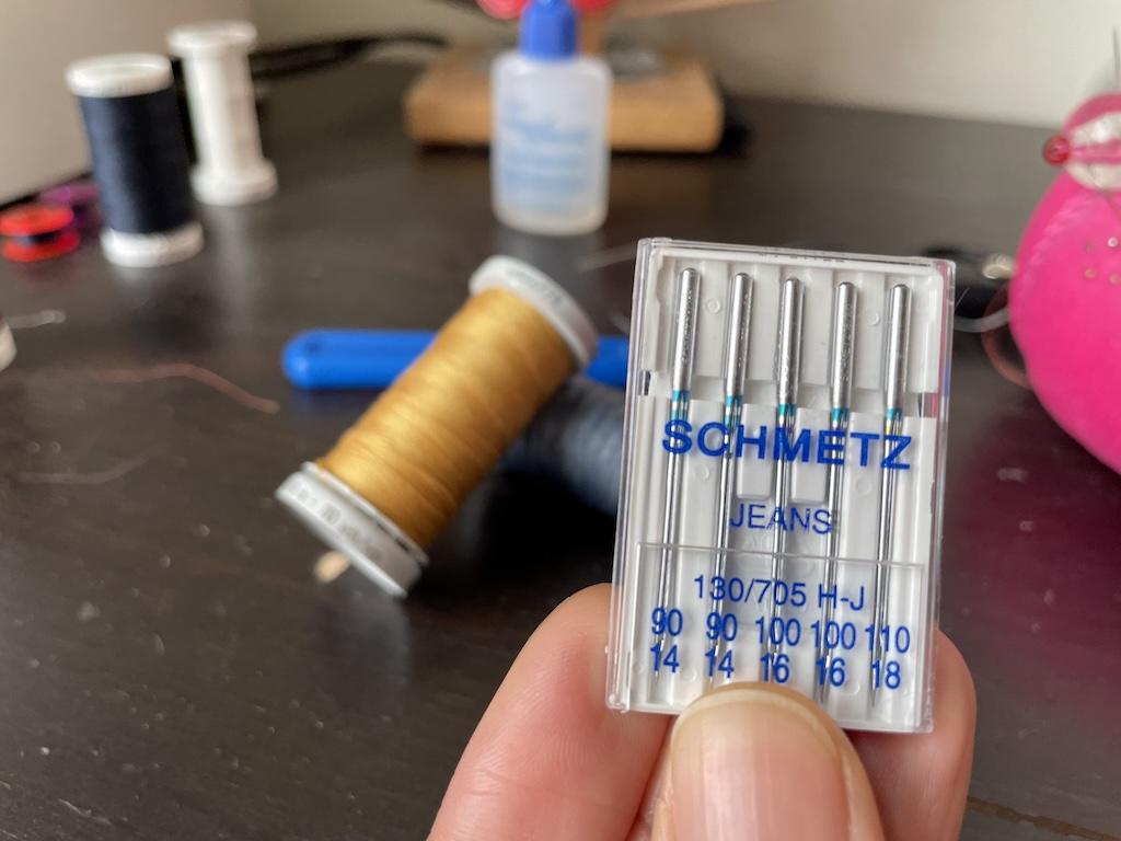 Jeans needles Luna used to make her denim skirt and gold topstitch thread in the background