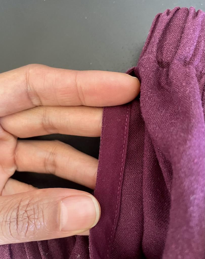 Close up view of Luna’s linen pants pocket with bias tape inside