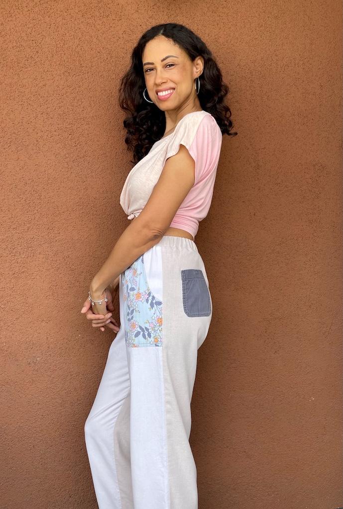 Side view of Luna smiling to the camera wearing her pants mockup made from Simplicity S9050