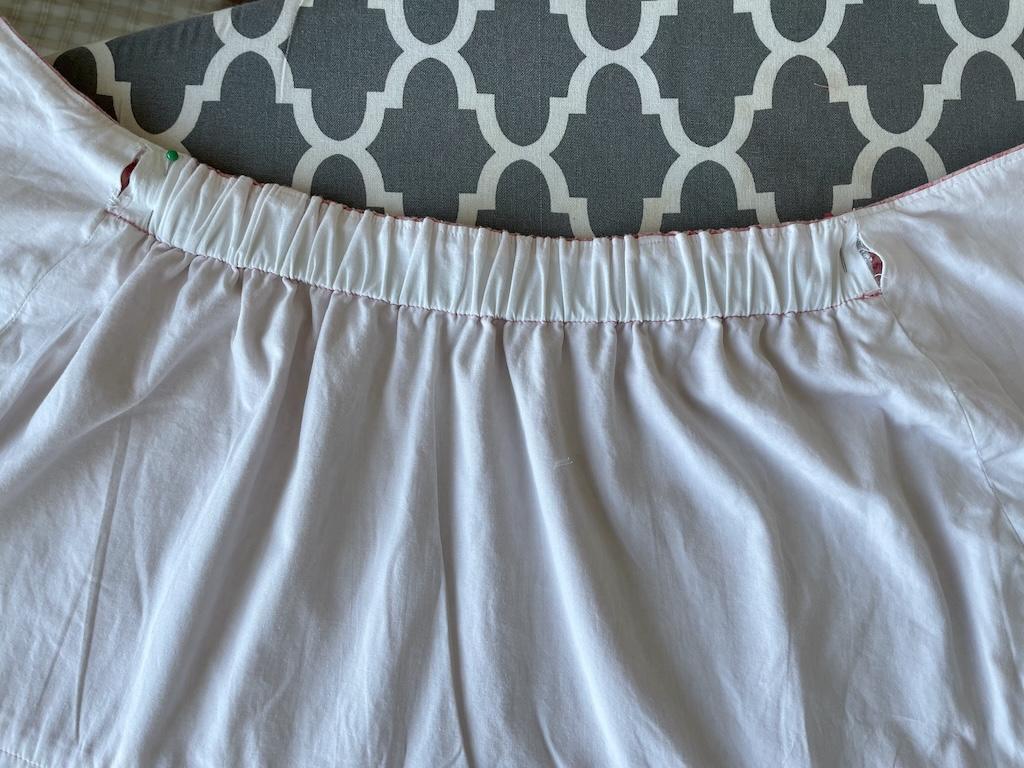 View of the back of Luna’s wrap skirt casing showing straight pins through both sides of openings