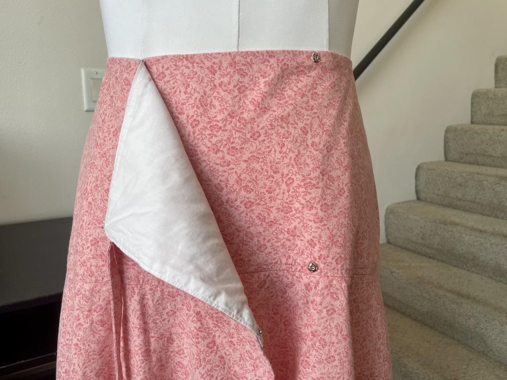View of snaps on the front yoke of Luna’s tie wrap skirt on the dress form