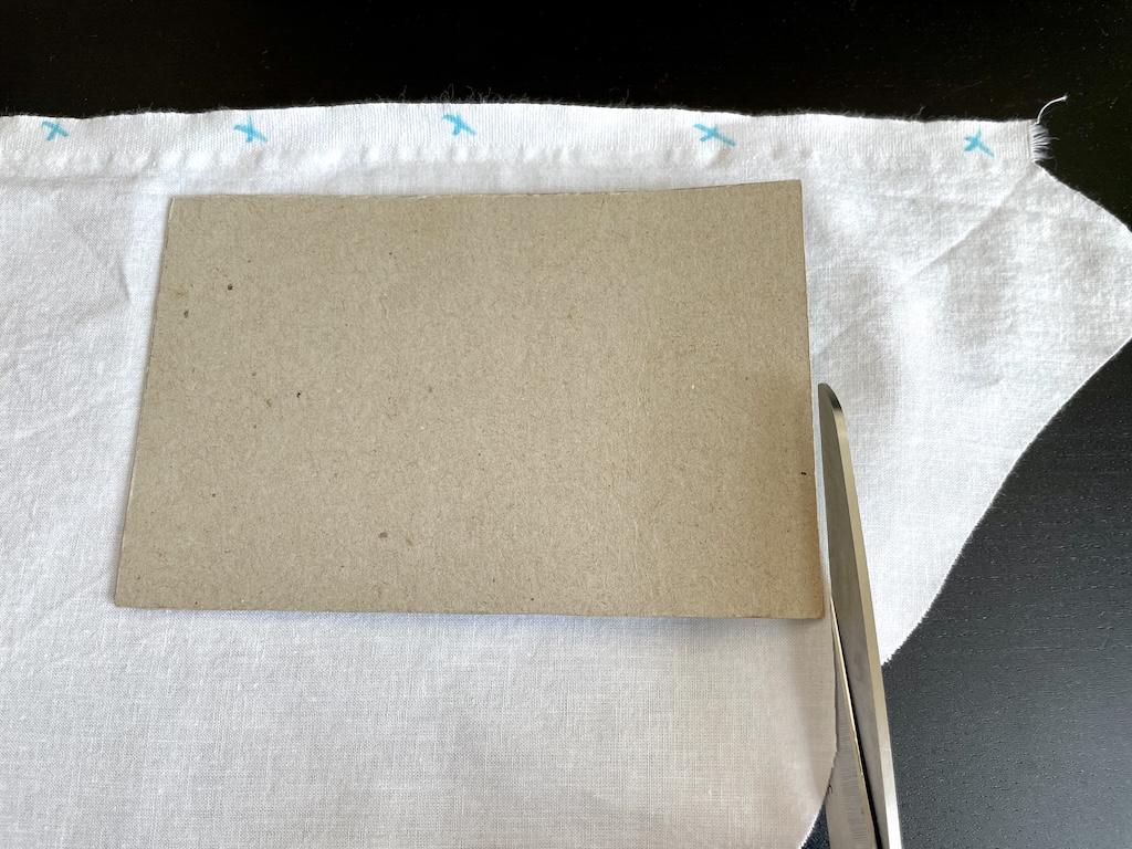 Close up of scissor blade cutting fabric to make a swatch