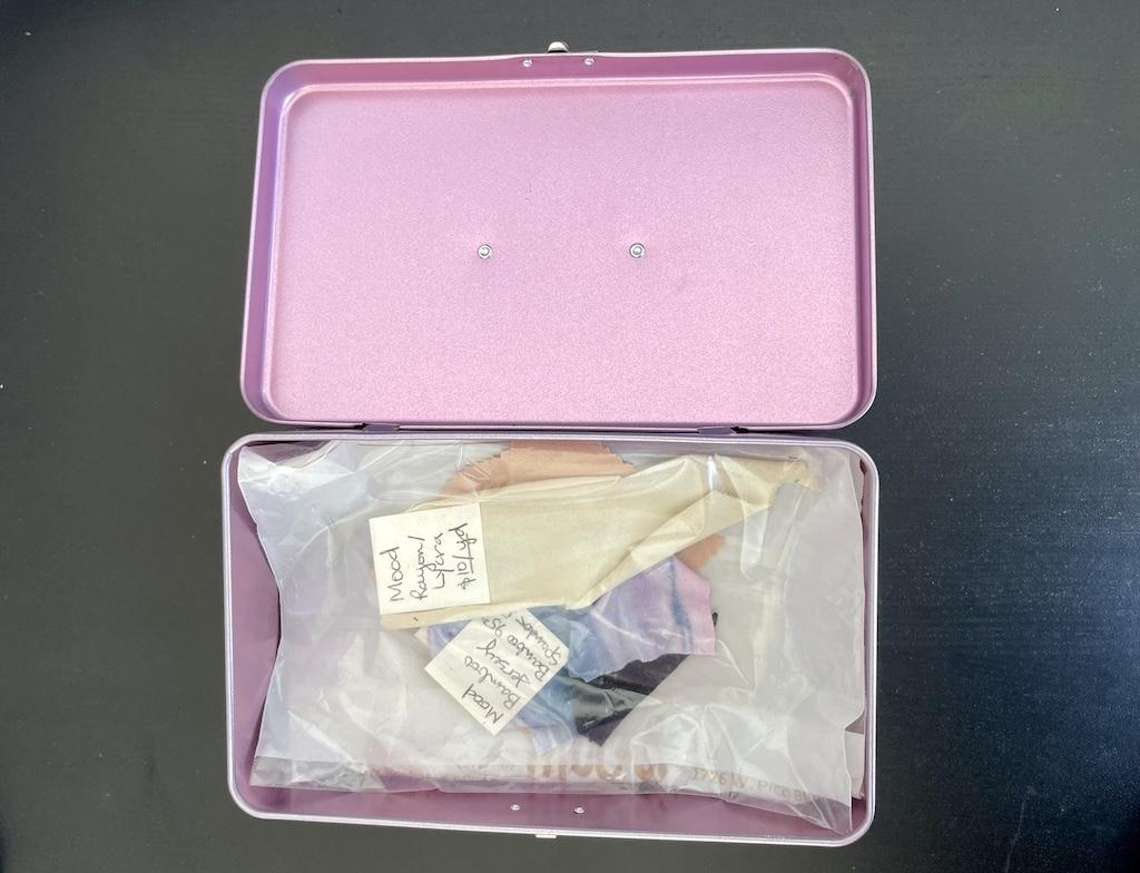 Overhead view of Luna’s container with her fabric swatches stored inside