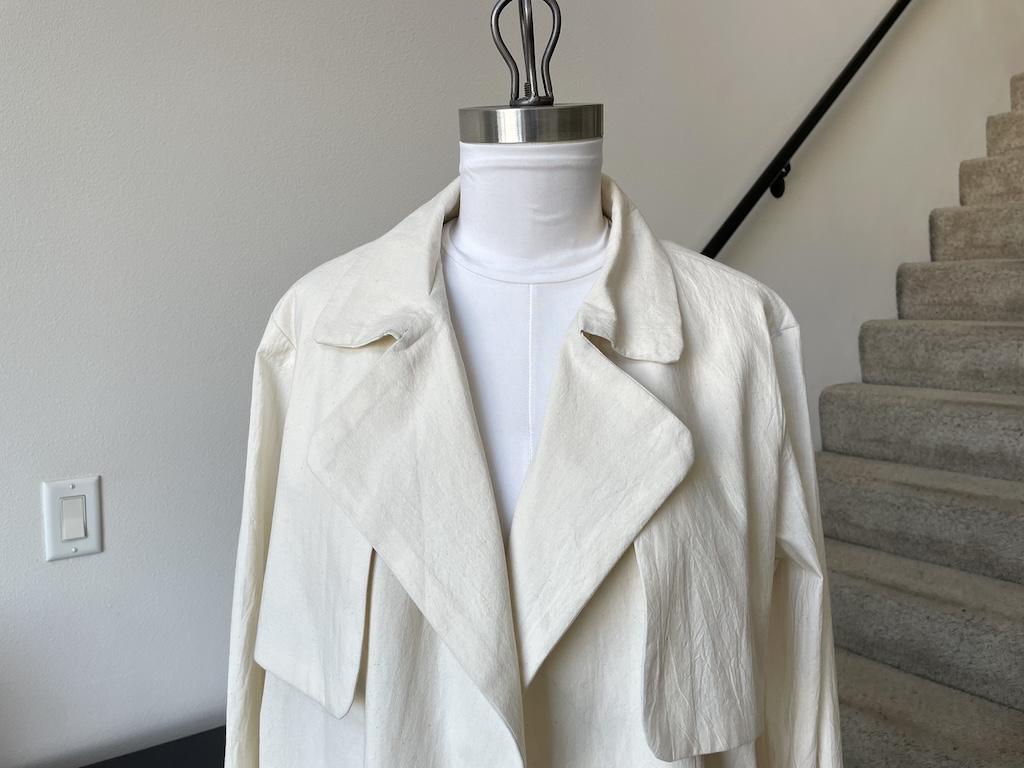 Front close up view of collar and lapel of Luna’s mockup trench coat on her dress form