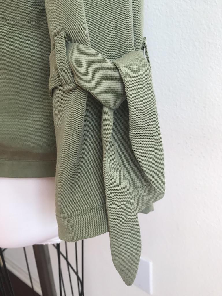Close up view of wrist ties on Luna’s soft trench coat 