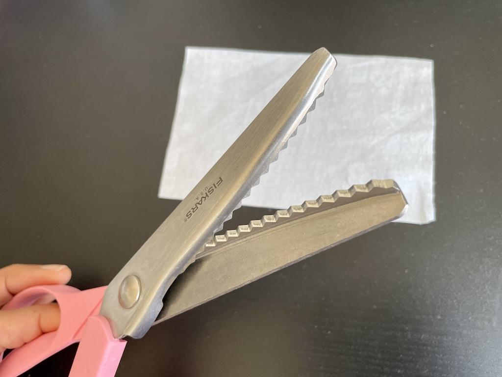 Close up of Luna’s pinking shears with fabric swatch in background