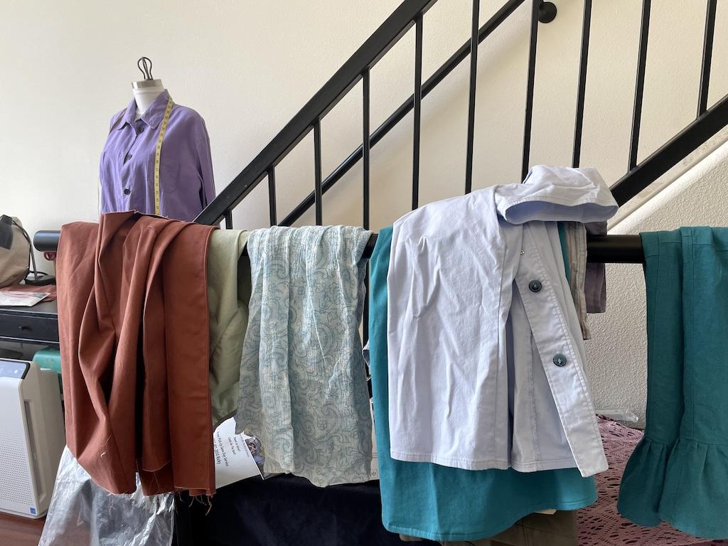 View of Luna’s DIY clothes hanging on a rack in her sewing room