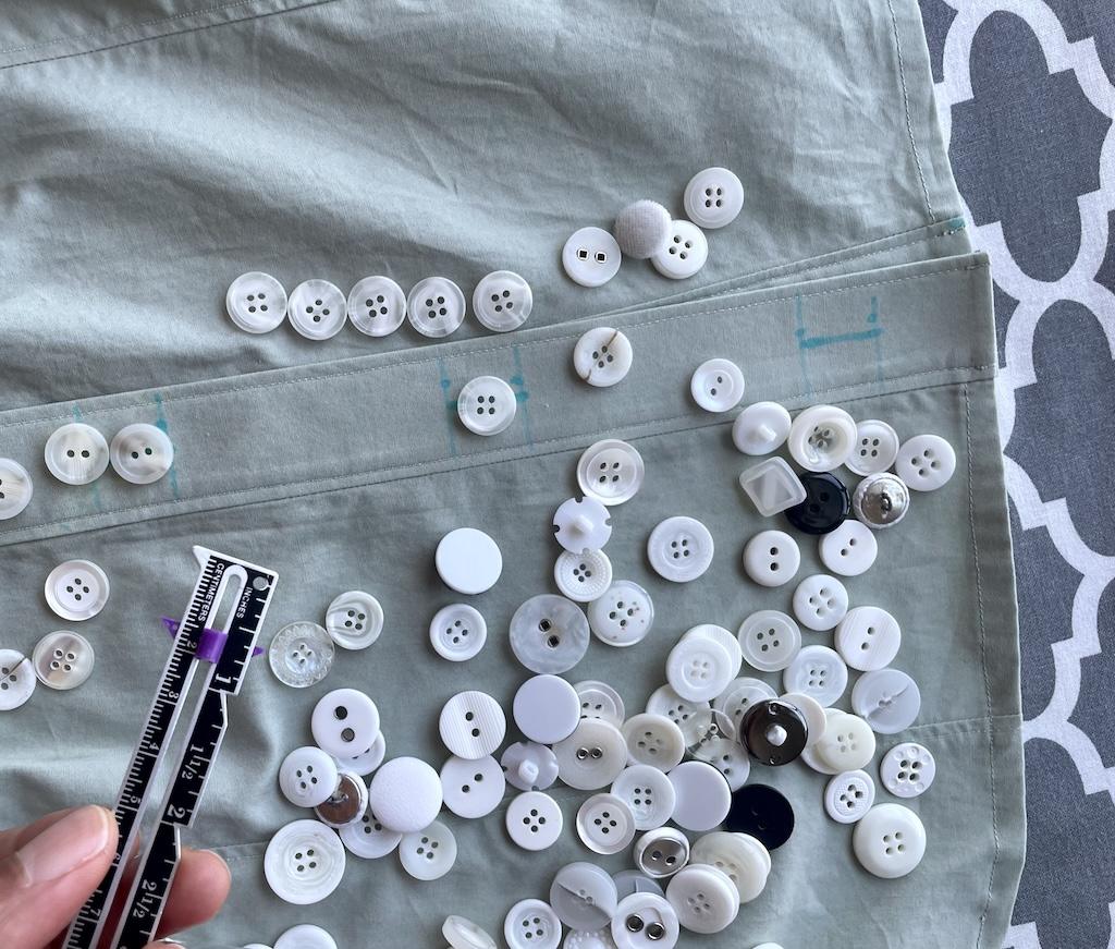 Luna’s hand holding ruler and many buttons on her DIY shirt