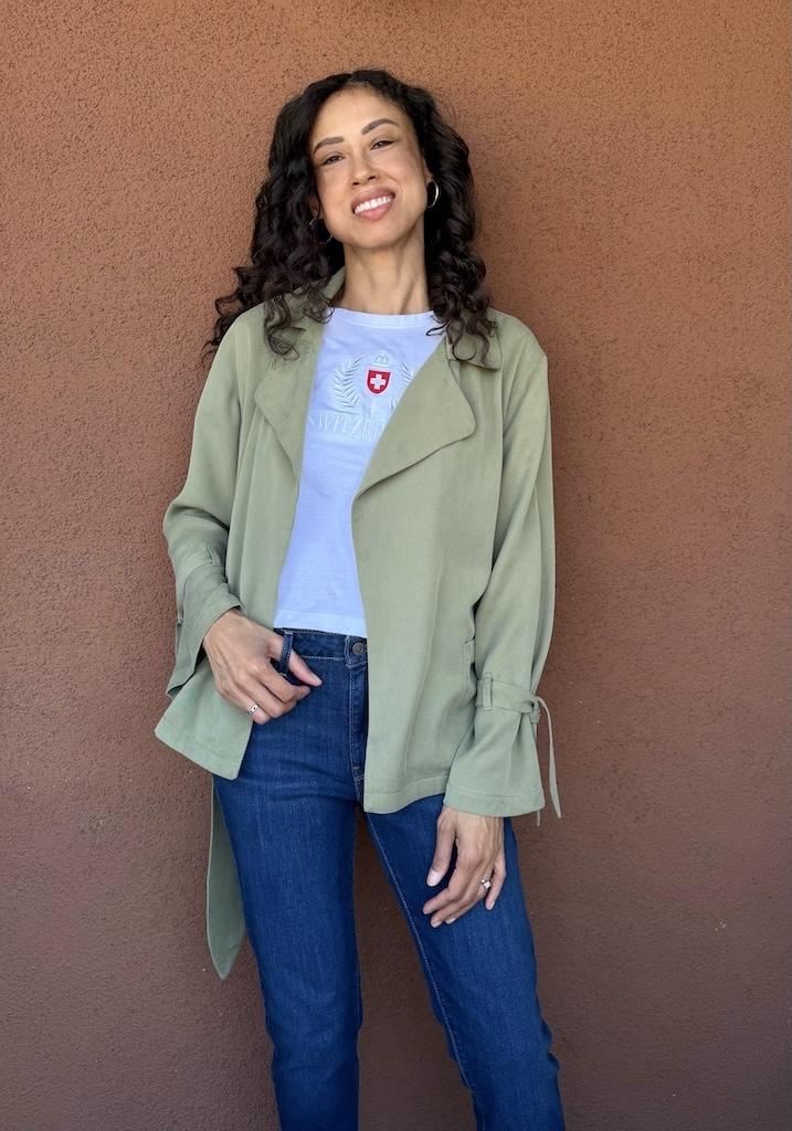 Front view of Luna smiling and wearing her DIY soft trench coat in light green tencel twill fabric