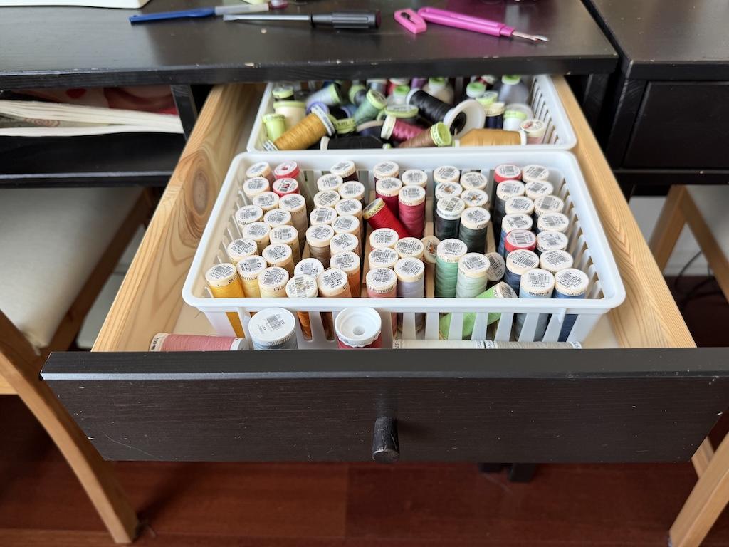 View of thread in basket inside drawer of desk that Luna uses in her sewing room