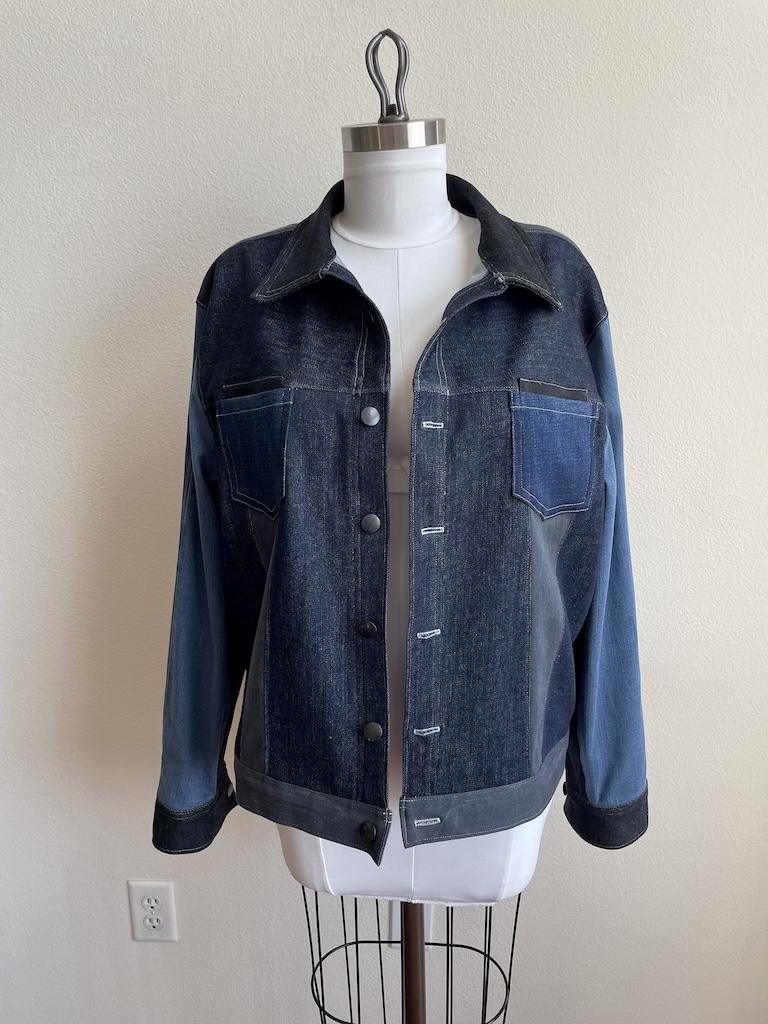 Front view of Luna’s DIY color blocked denim jacket on the dress form, that she made with Simplicity S8845 sewing pattern