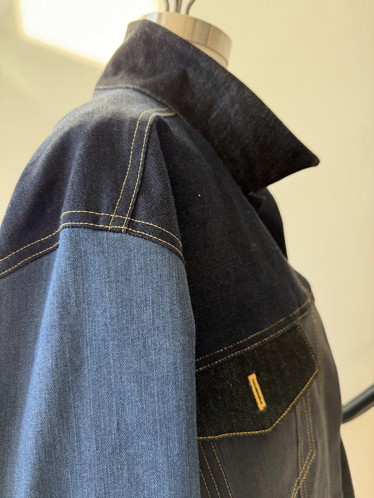 Side view of topstitching on Luna’s DIY color blocked denim jacket on the dress form