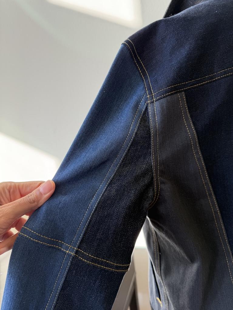 Close up view of double topstitching on sleeve that Luna made on her DIY men’s color blocked denim jacket