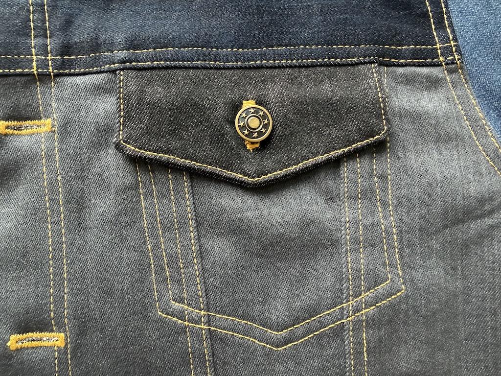 Jeans button attached to pocket of jacket that Luna made