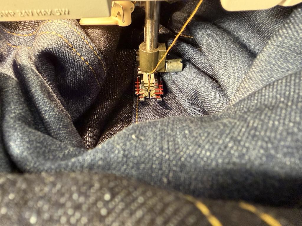 Close up view of Luna’s sewing machine double topstitching her blocked denim jacket
