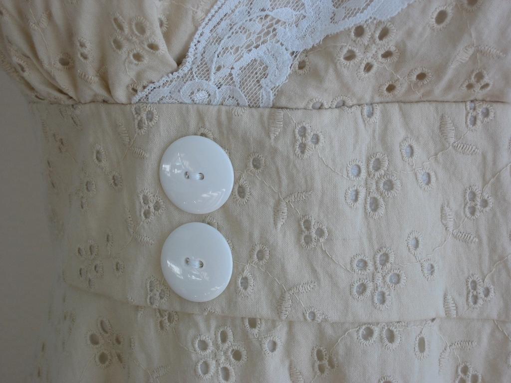 Close up view of buttons on DIY eyelet dress that Luna made