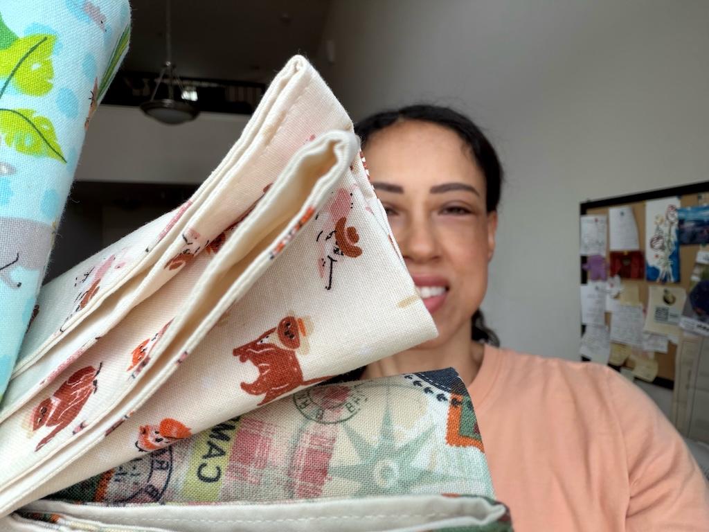 Close up of Luna smiling in background holding DIY reversible cloth napkins