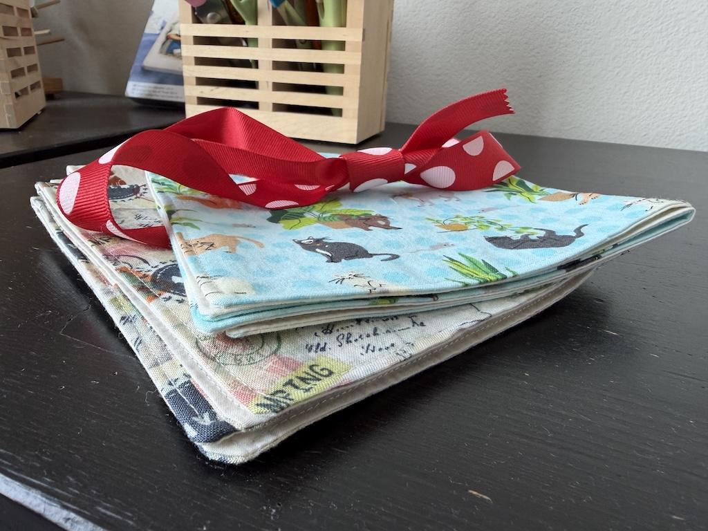 Close up of DIY reversible cloth napkins with ribbon that Luna made with quilting cotton
