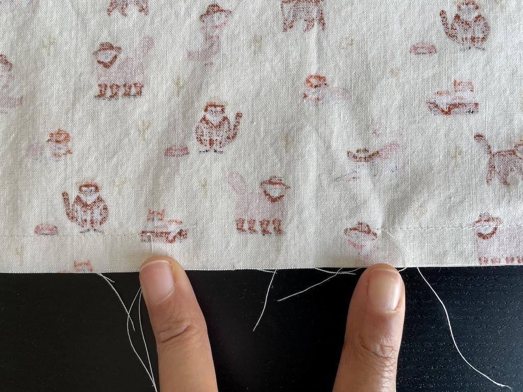 Close up view of Luna’s fingers and opening in seam when sewing DIY cloth napkin