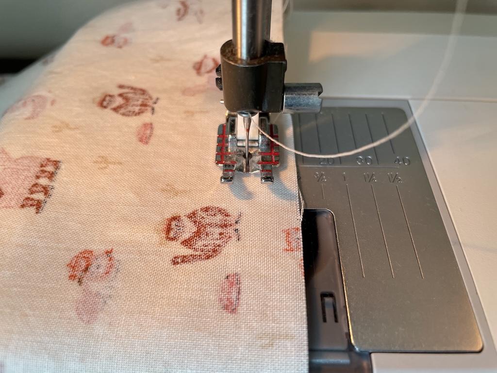 Close up of sewing seam on DIY cloth napkin on sewing machine