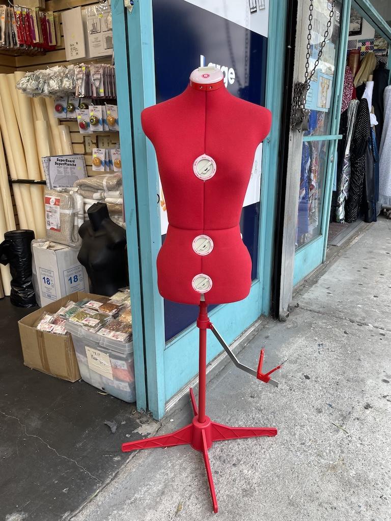 Singer red adjustable dress form outside sewing supplies store