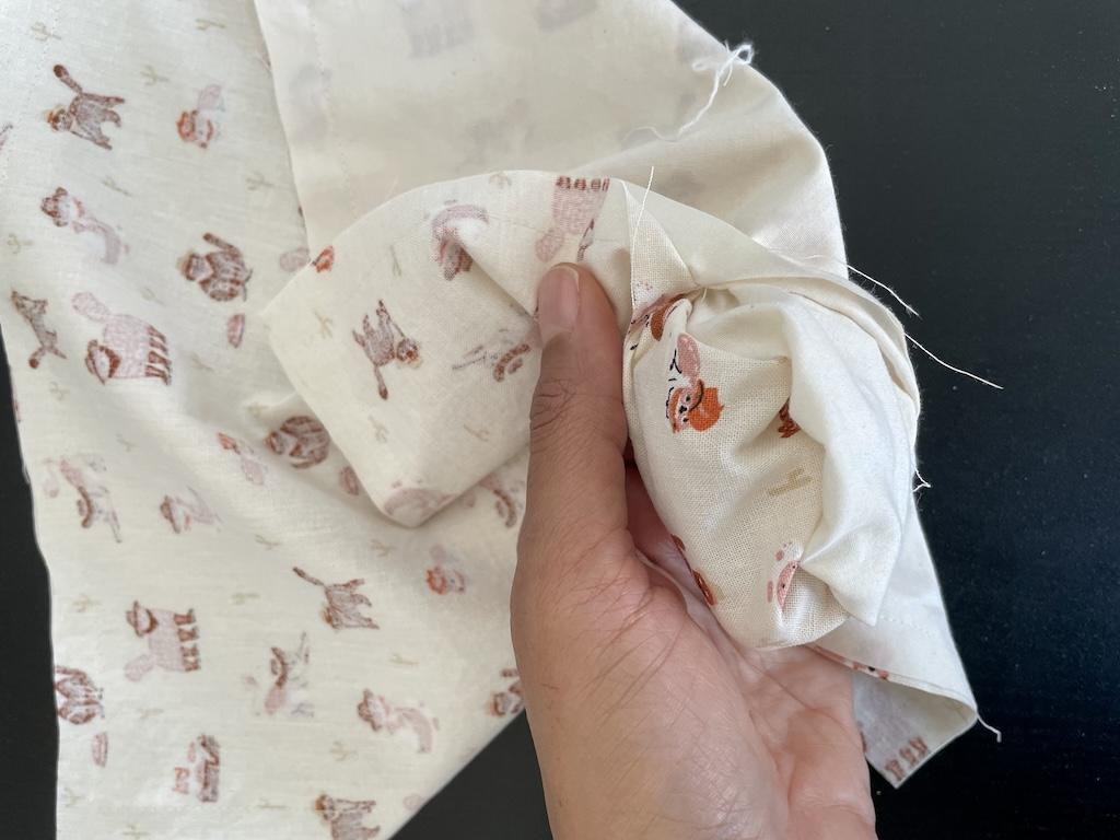 Luna’s hand turning DIY cloth napkin inside out