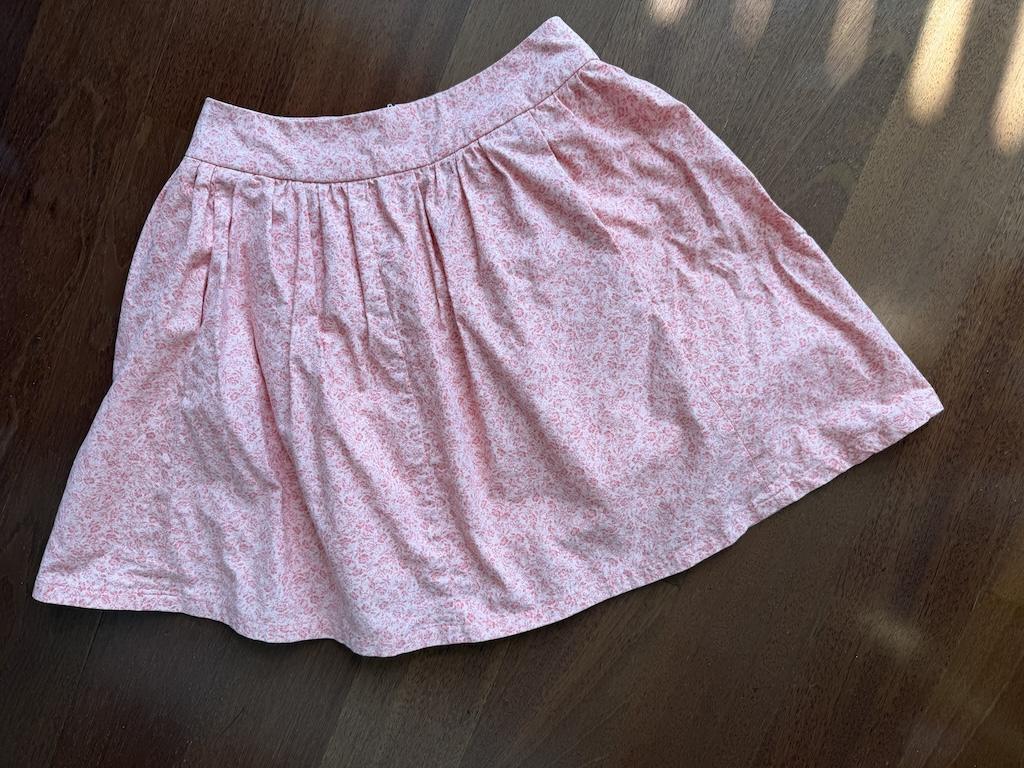 Luna’s pink cotton gathered skirt on the floor of her sewing room