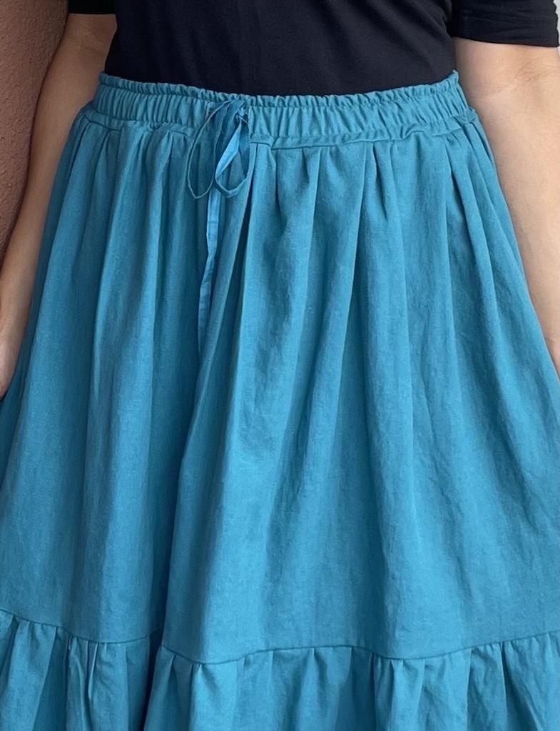 Close up of Luna’s DIY tiered maxi skirt waistband in linen fabric with drawstring waistband
