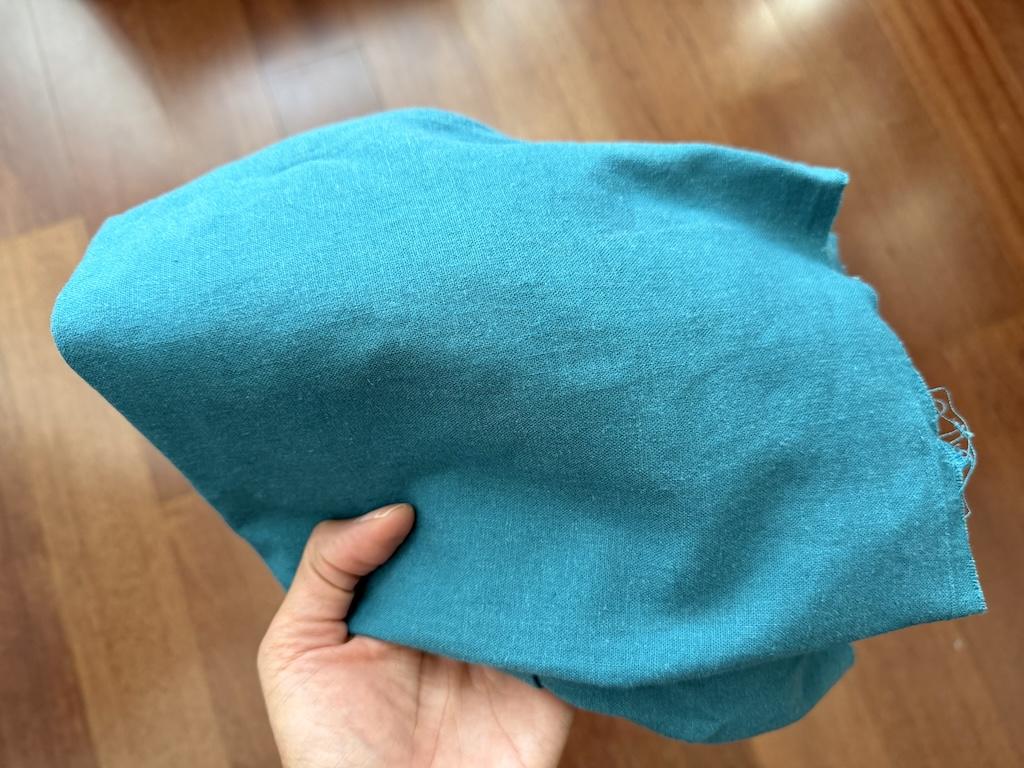 Turquoise rayon linen blend fabric Luna used for making her garment